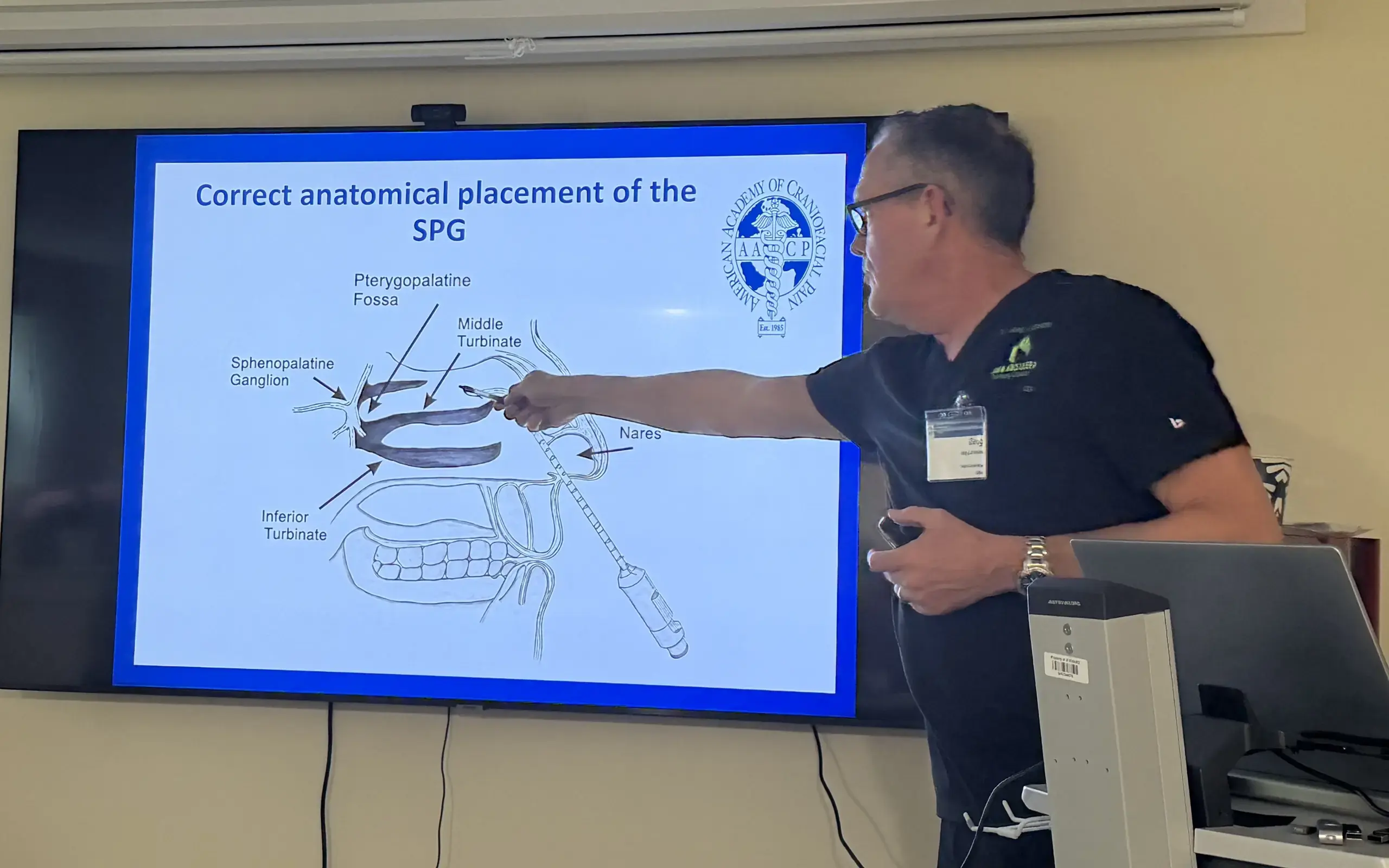 Dr. Greg Larson teaching craniofacial anatomy to a room of clinicians.