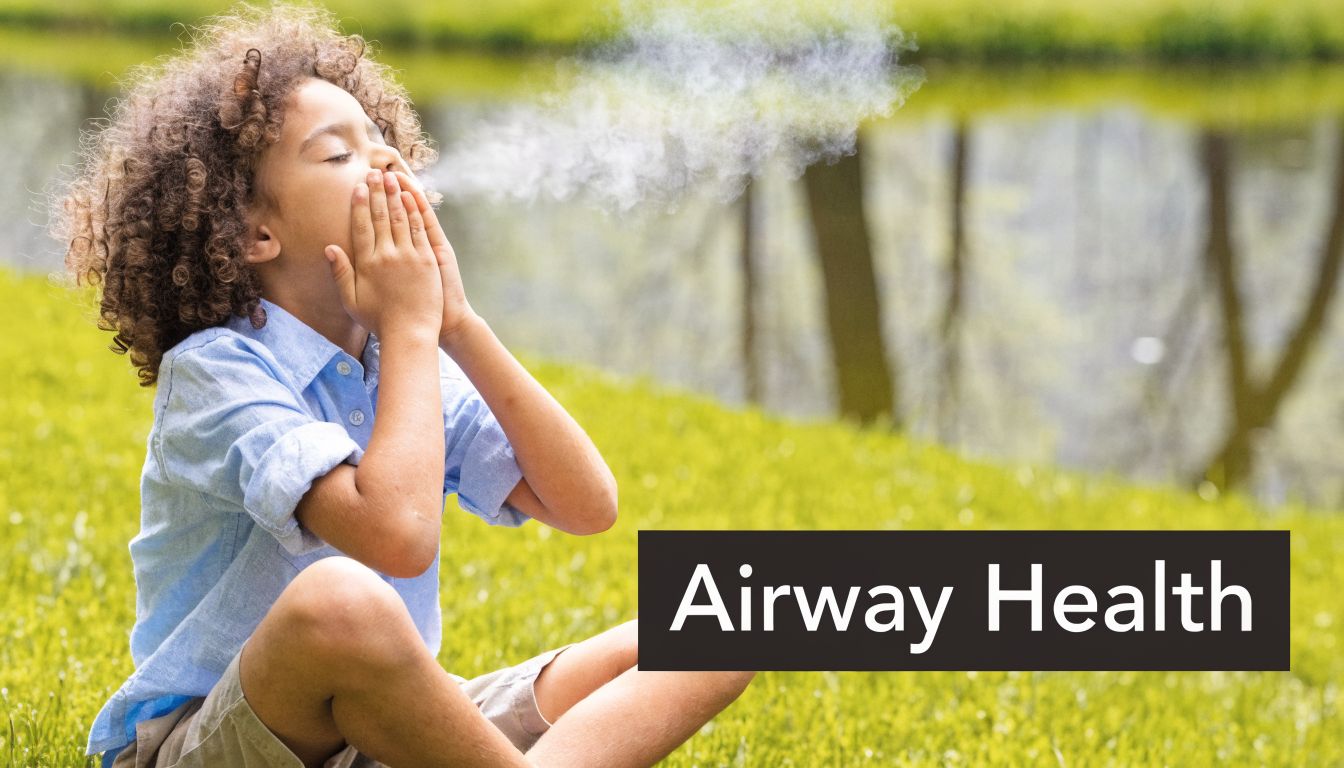 A child with curly hair breathing out into their cupped hands outdoors, representing airway health and wellness.