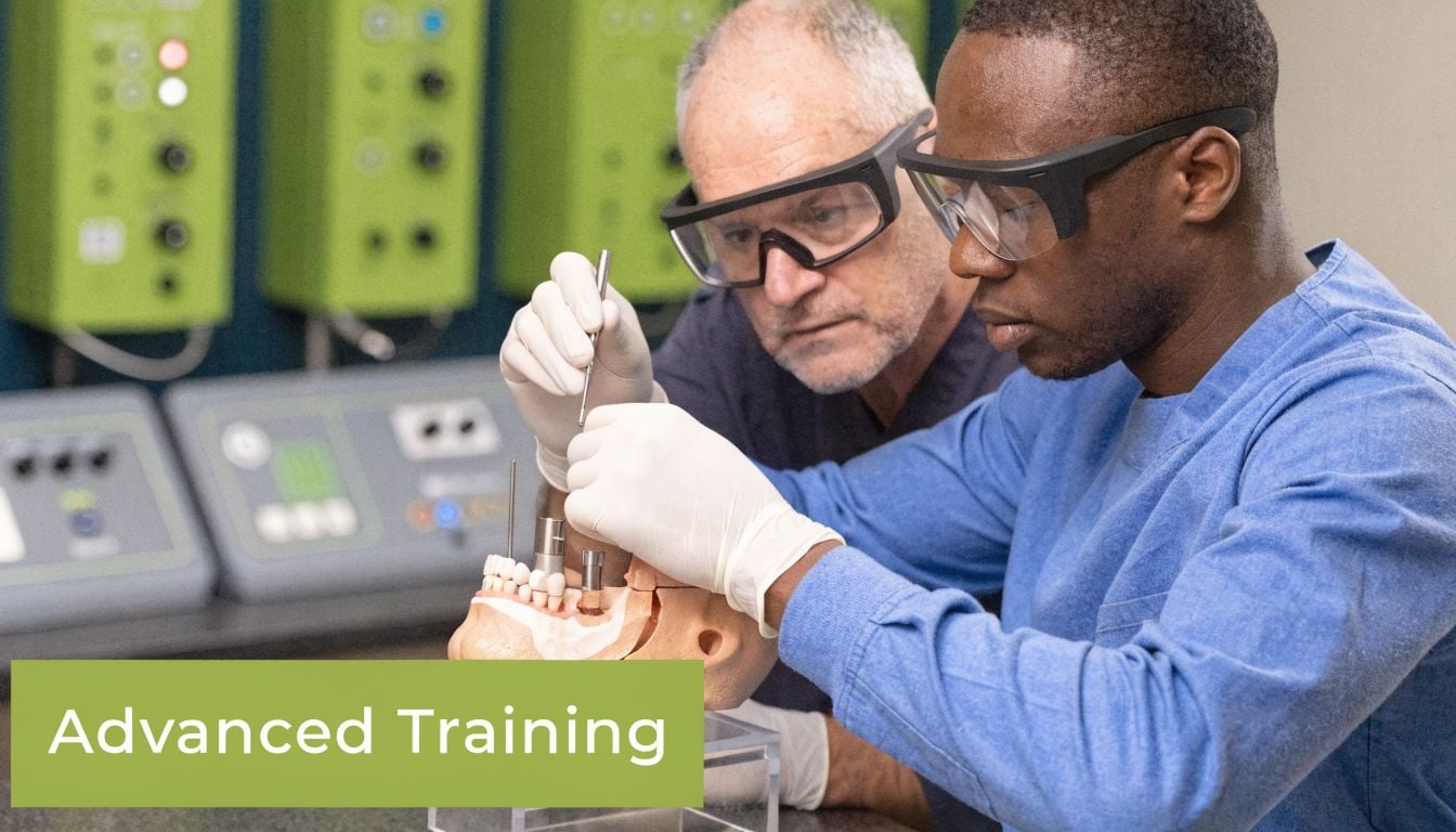 A professional dentist providing advanced surgical training to a student on a realistic dental mannequin model.