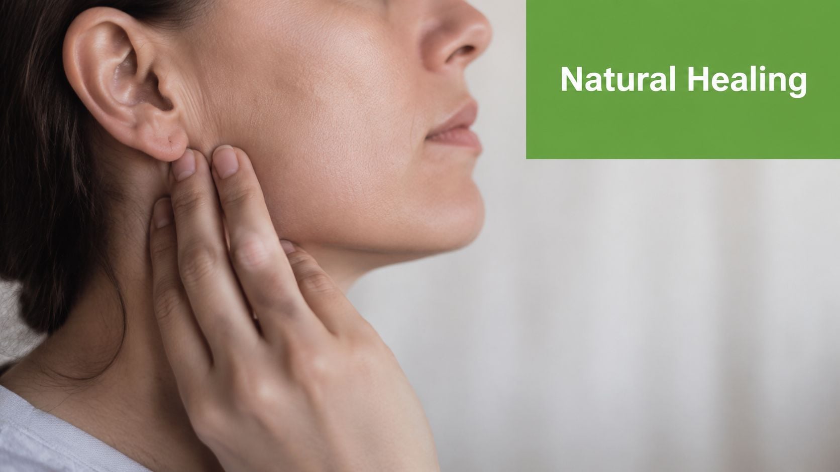 A woman gently touching her jawline, symbolizing awareness of potential jaw issues or natural healing focus.
