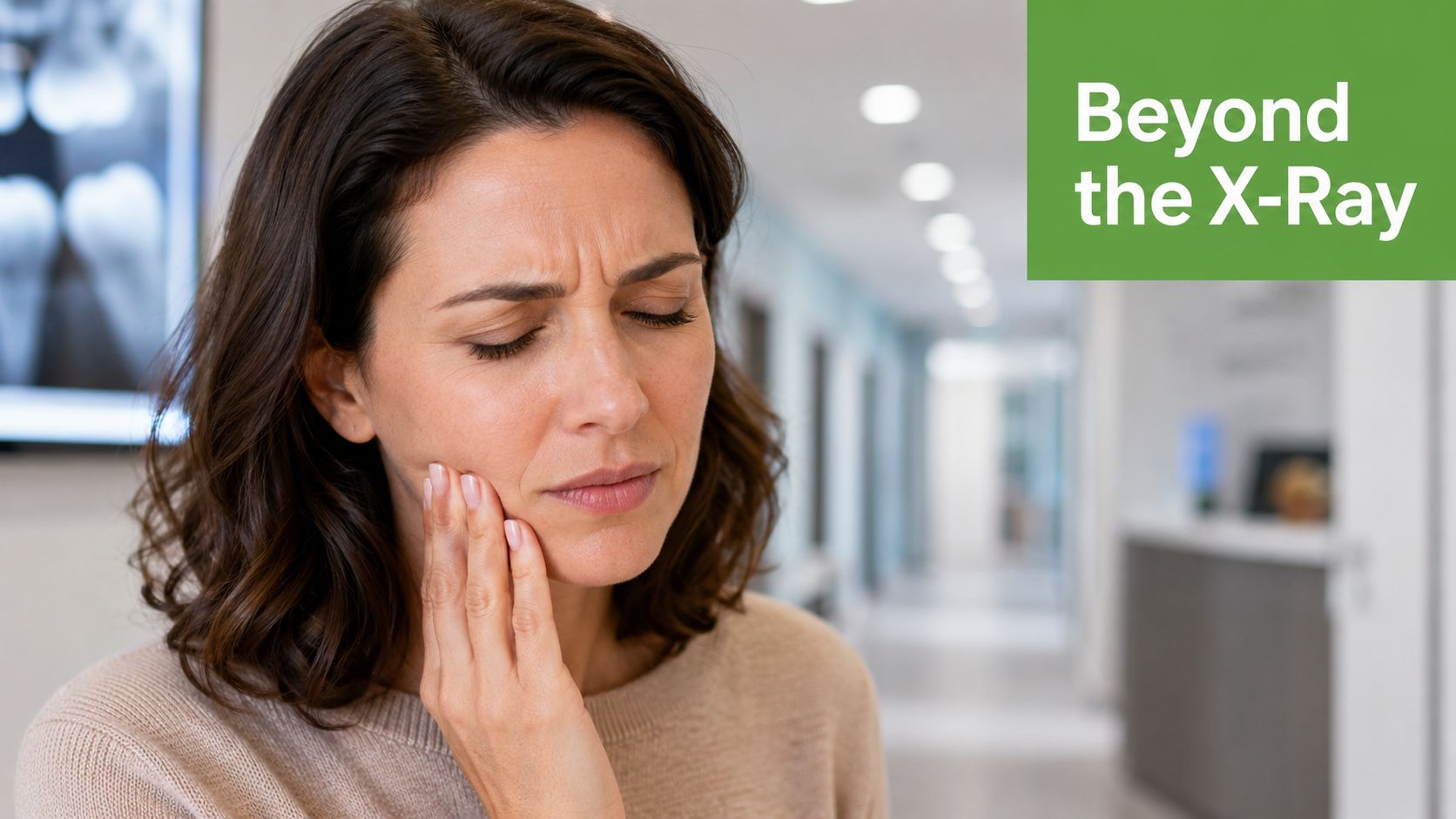 A woman holding her cheek in pain while standing in a dentist office corridor.